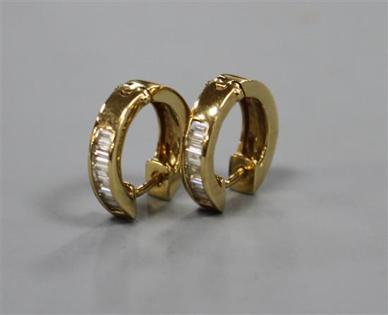 A pair of modern 750 yellow metal and seven stone baguette cut diamond set half hoop earrings, approx. 14mm, gross 4.2 grams.